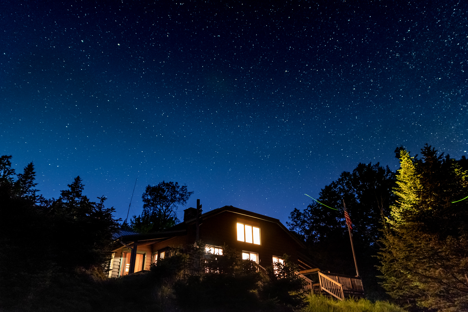 a lit lodge on a starry night